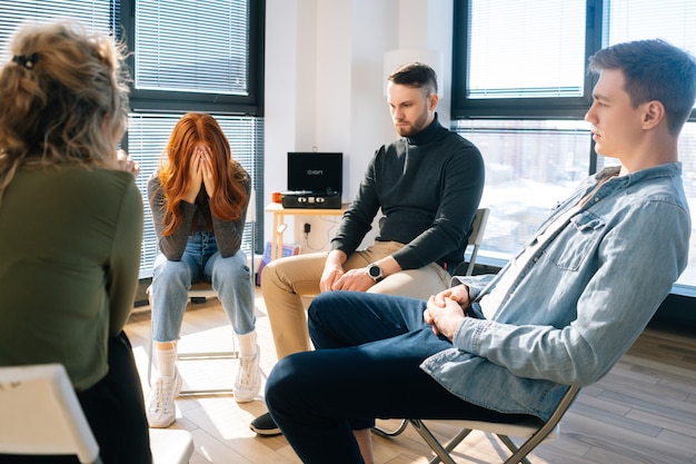 front-view-sad-frustrated-young-woman-sharing-problem-group-therapy-sitting-with-head-bowed-concept-group-consulting-mental-health-problem-with-psychologist_482921-2631.jpg